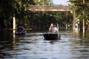 A woman speaks on a cellphone in Bangkok during a 2011 flood.