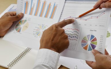 Business people group meeting. Teamwork with business people analysis financial graphs and charts on desk at meeting room. Business competition, conflict concept. Two businessman are trying to come to an agreement.