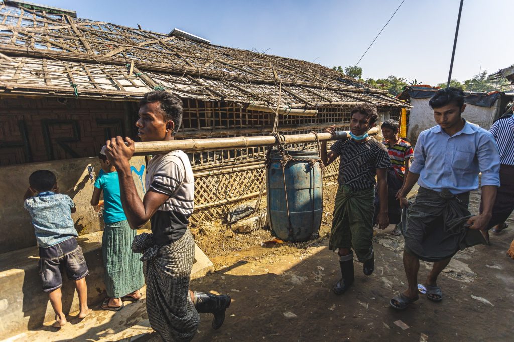 Rohingya Refugee Camp 11 (Block A, C, F, G, D) : Two rohingya men carrying drinking water to their shelter