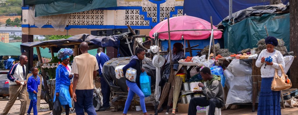 Manzini, Swaziland - 10/30/2019: Colorful market where local people and tourists buy crafts and souvenirs, household items, fruits and vegetables, traditional Swazi medicine. Eswatini, Africa