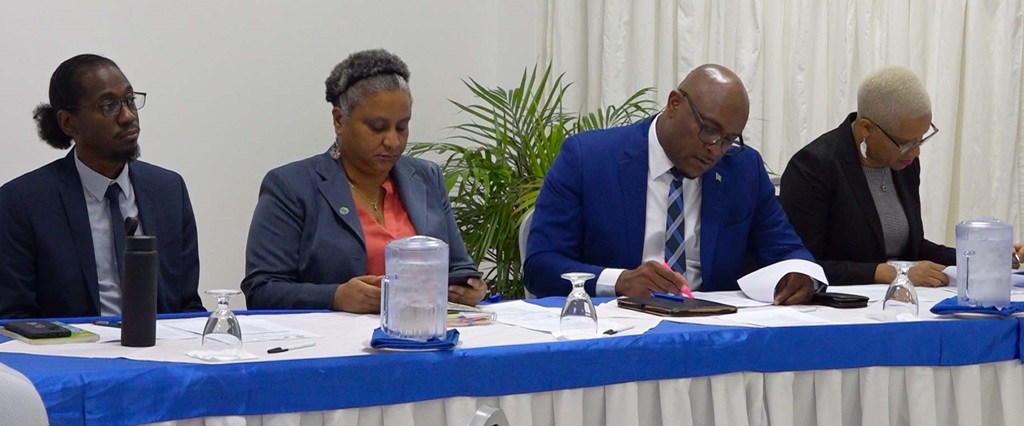 Four people read through documents