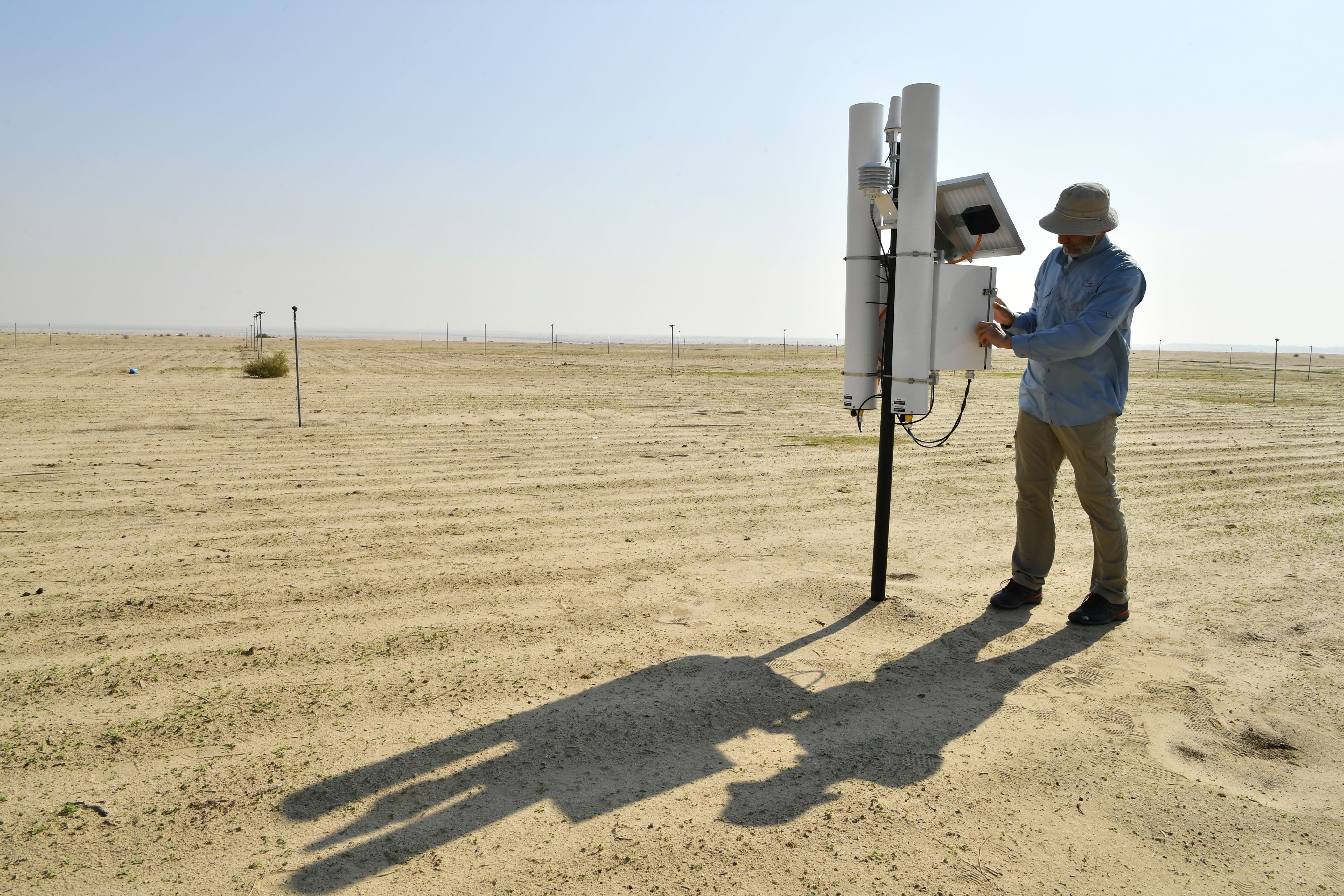 Barley in the Desert: Kuwait Progresses in the Development of a New Variety Using Nuclear Techniques. Abdullah Salem Alshatti, the principal researcher at the KISR Desert Agriculture and Ecosystem Program, is checking the battery and the working condition of the cosmic ray neutron sensor.&nbsp;Photo Credit: Dean Calma / IAEA