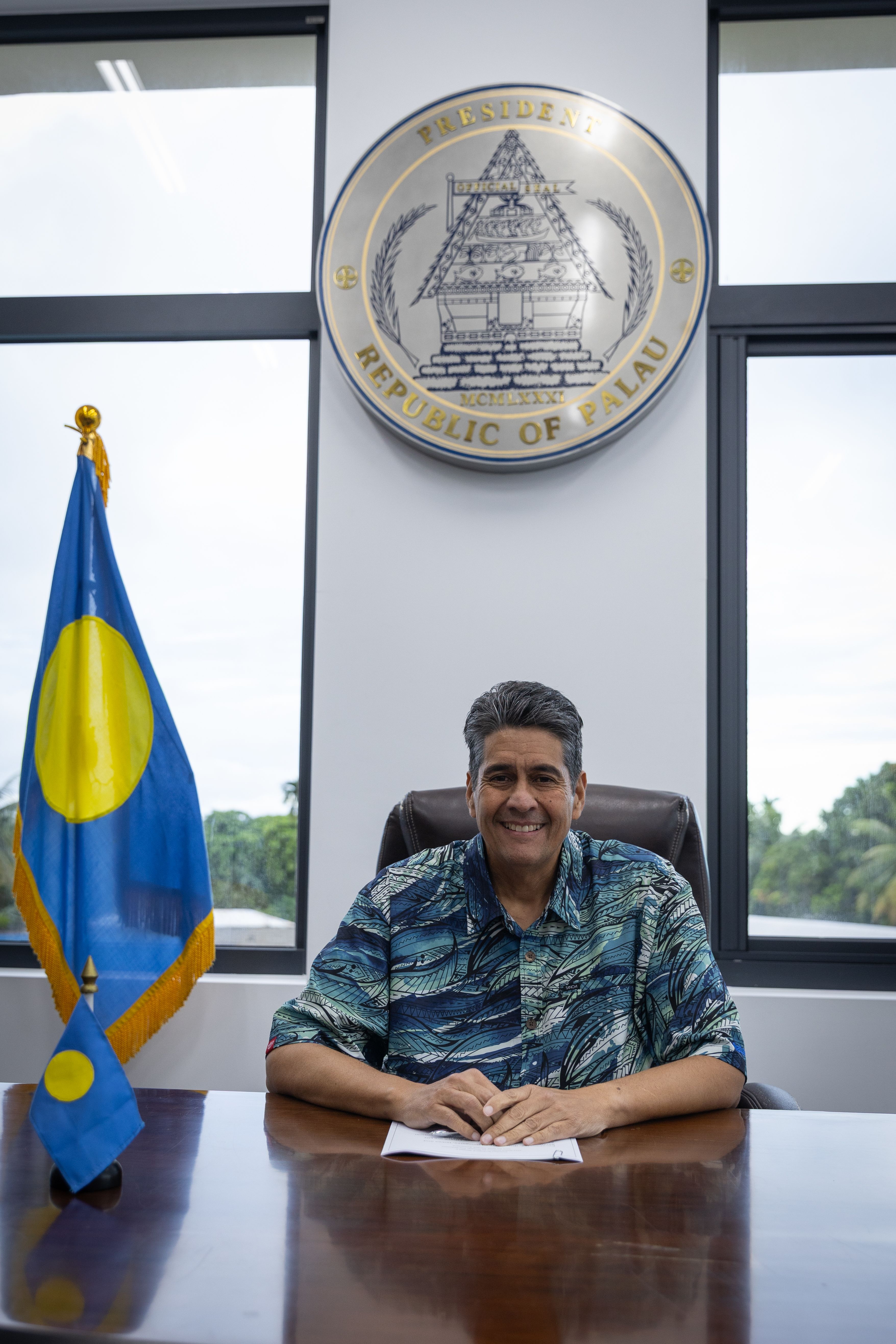 The president of Palau sitting at his desk.